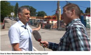 Screencapture of Patrick being interviewed outdoors by Stephen Quinn. Quinn with a comically surprised expression, slightly blurred.